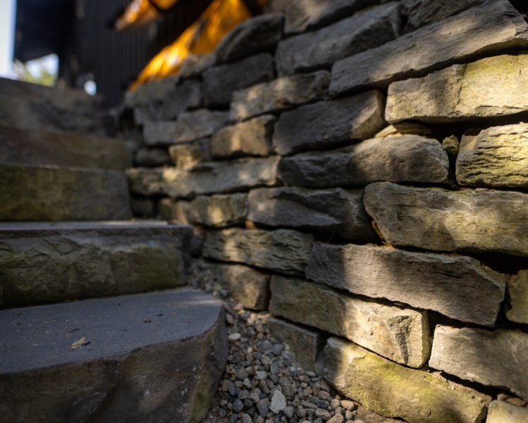 Illuminated stone wall steps night