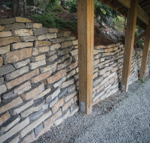 Timber post stone retaining wall